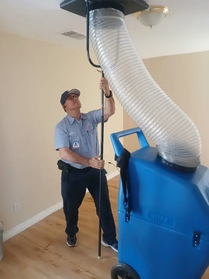 Furnace Tune-Up technician using HEPA equipment in Stratmoor